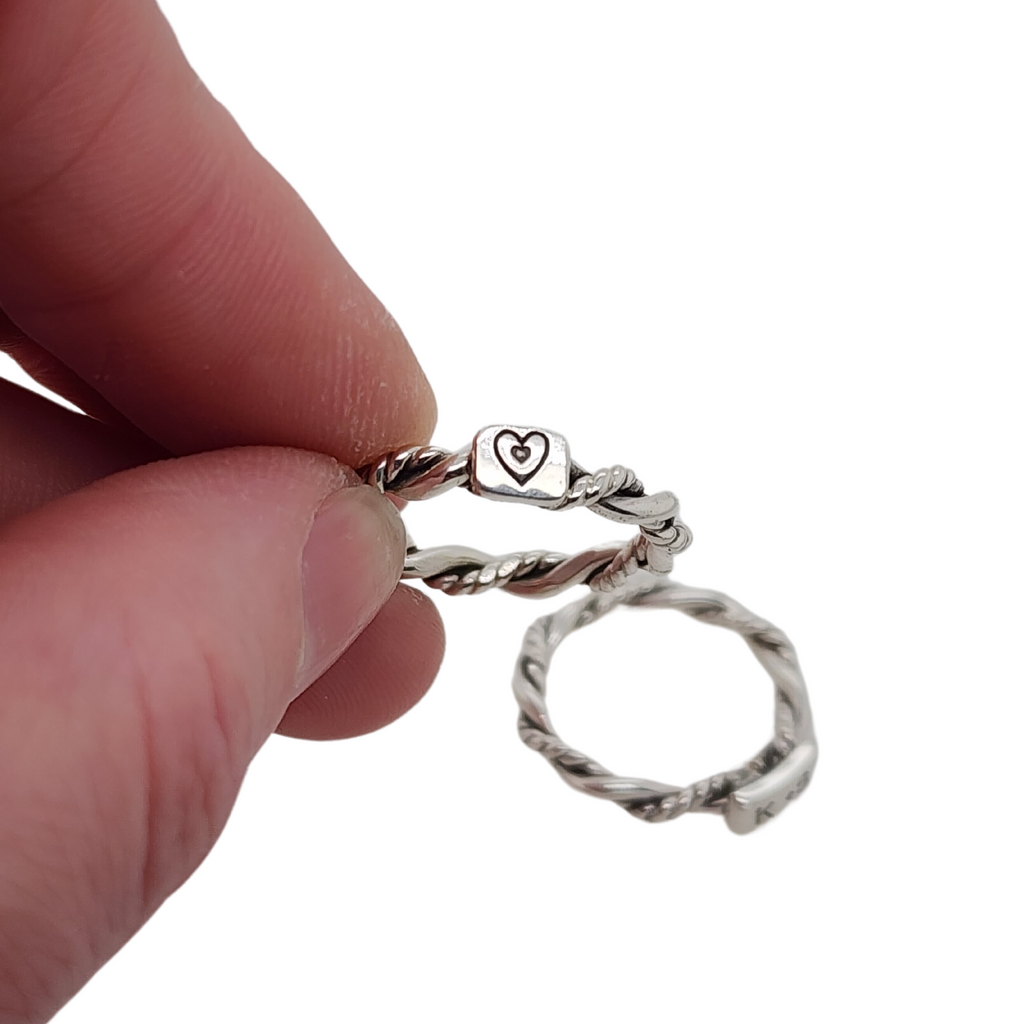 ring with twisted wires and a heart