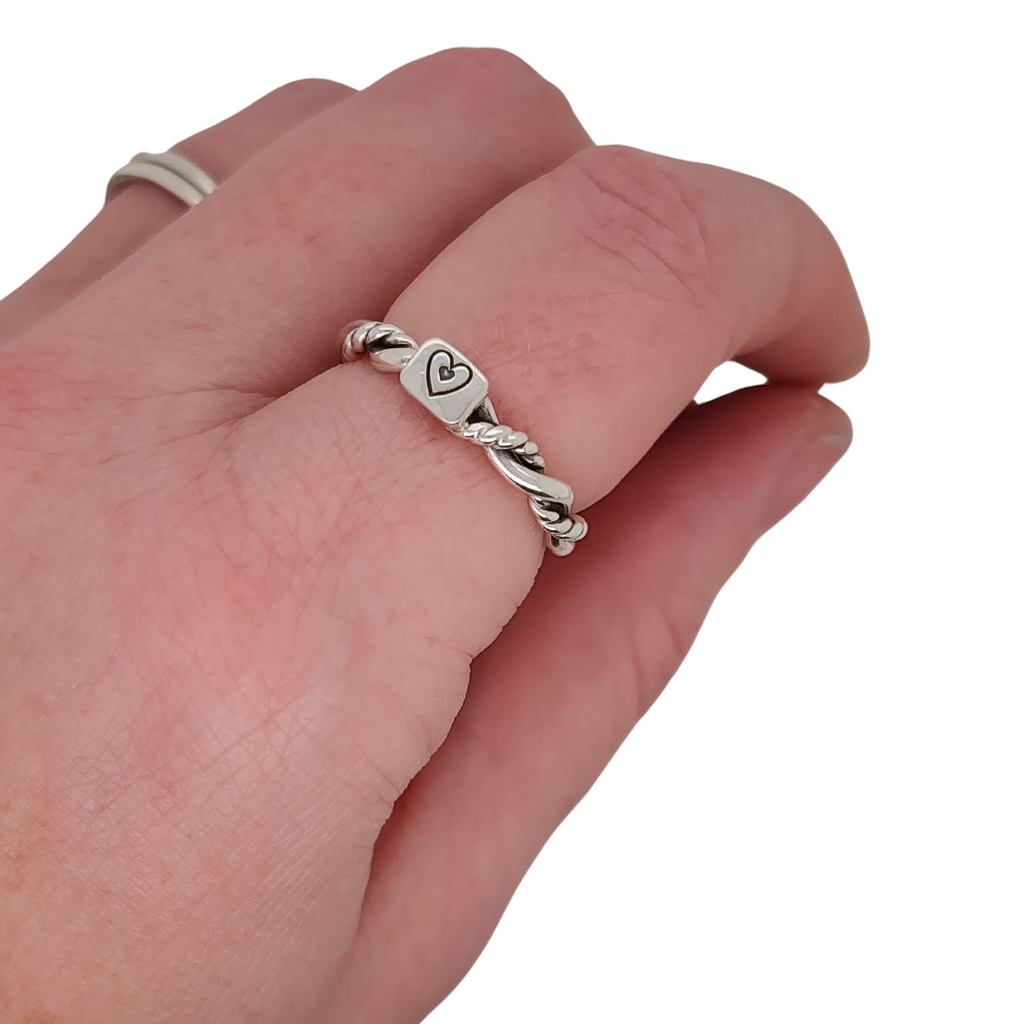 intertwined ring on finger