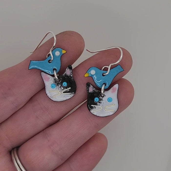 cat and bird earrings in hand for scale, see the back and front of the design