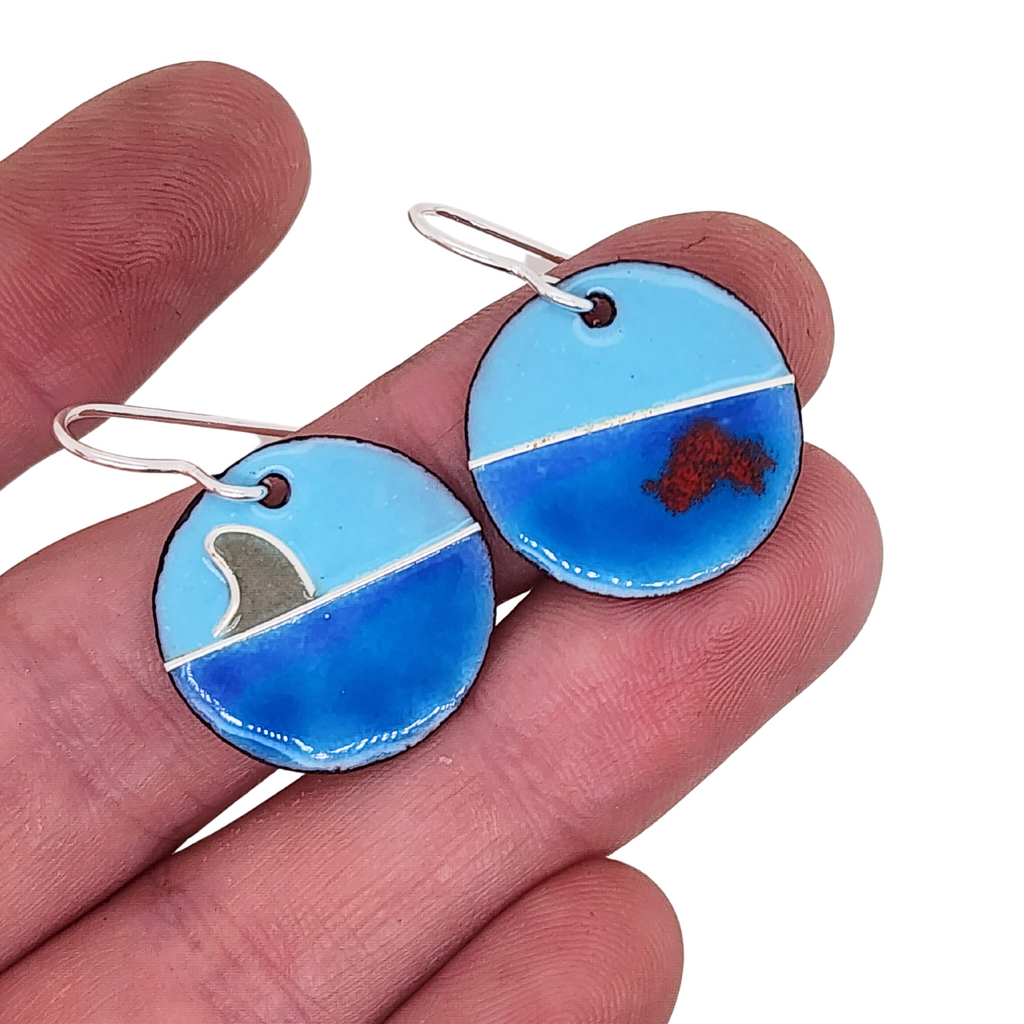handmade earrings with a shark fin and blood