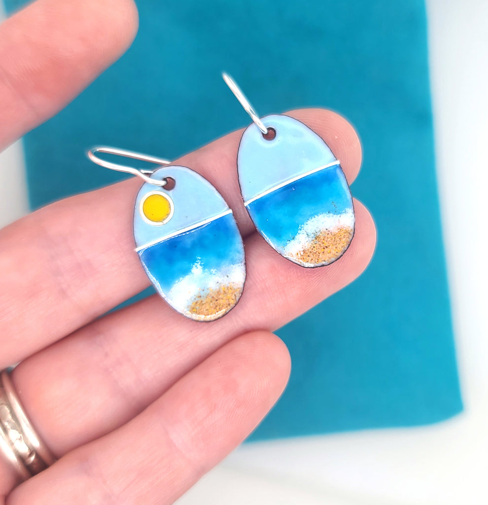 blue enamel earrings with a beach sunrise