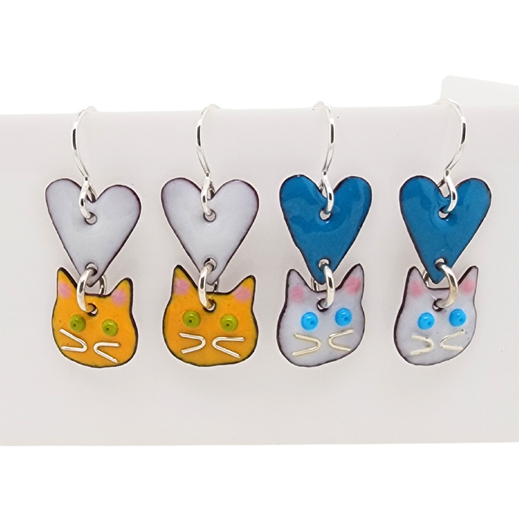 many different color combinations of cat earrings