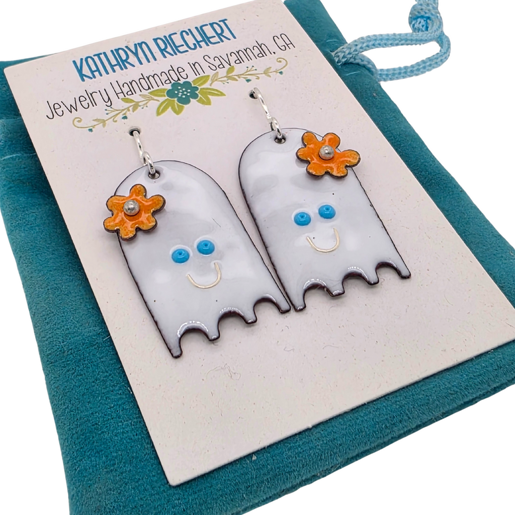 Ghost-shaped earrings with flowers on a branded card