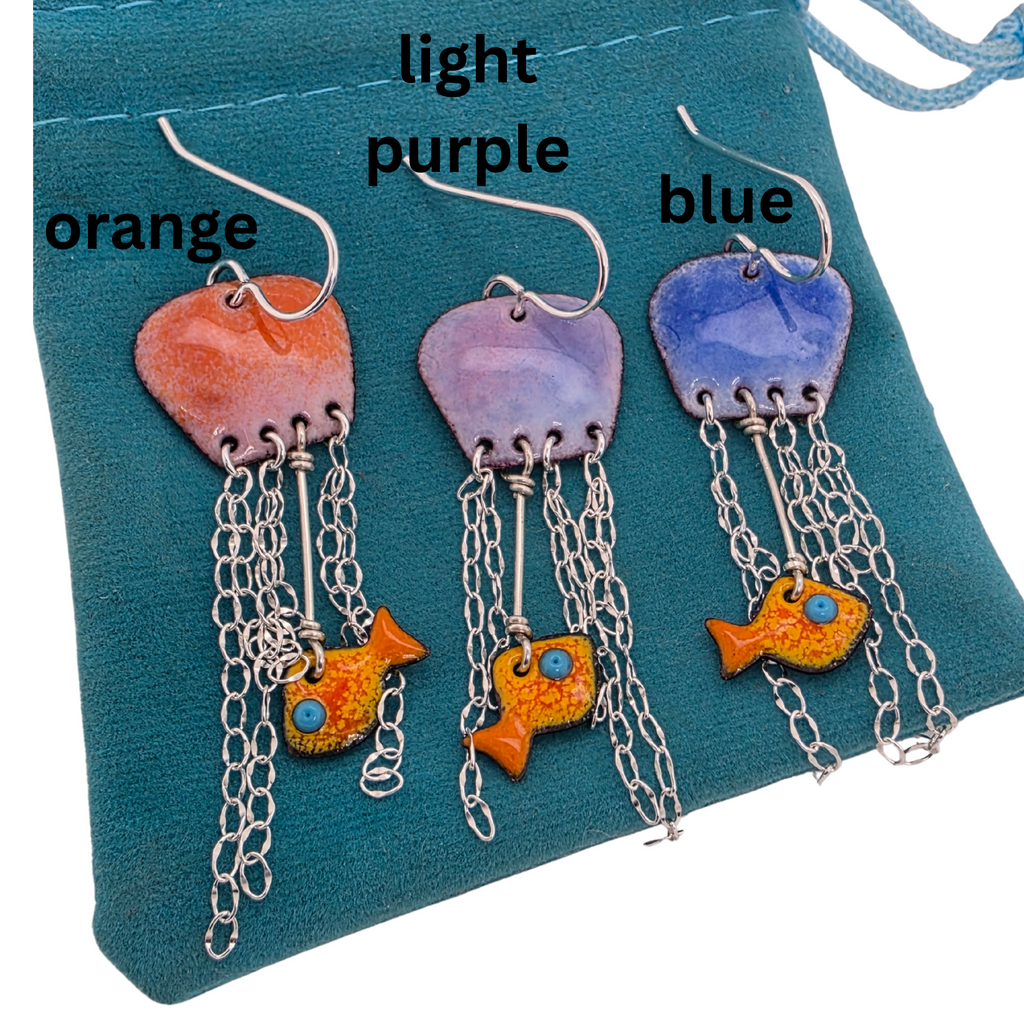 handmade jellyfish earrings made out of glass enamel fused to copper, with sterling silver chain dangling down as tentacles.  A small goldfish has been caught in the tentacles.