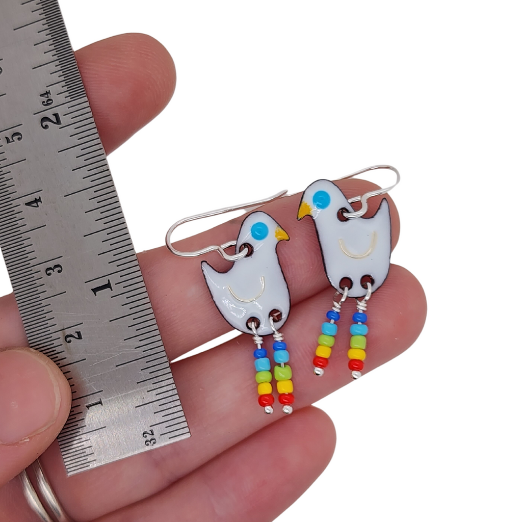 white birds with rainbow legs, made out of glass enamel and glass beads