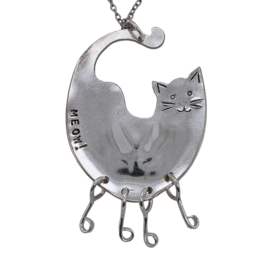 Silver cat-shaped pendant with 'MEOW!' on a white background