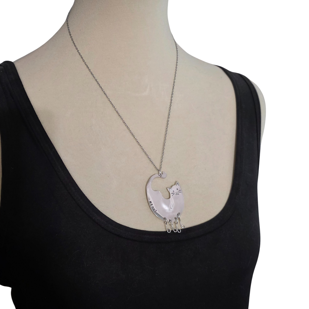Necklace with a cat pendant on a mannequin with a black top