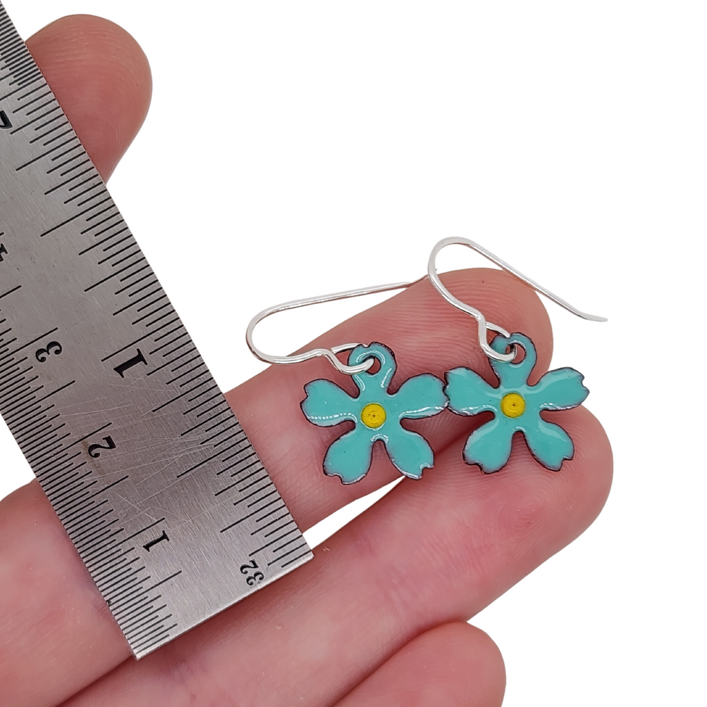 turquoise colored flower earrings with a yellow center