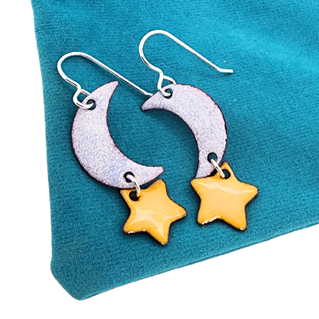 yellow stars hanging below a moon, earrings created from glass enamel