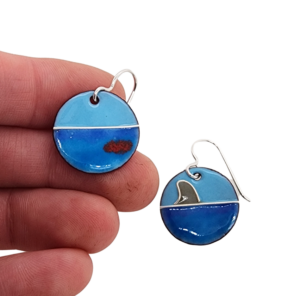 handmade shark attack earrings in hand for scale