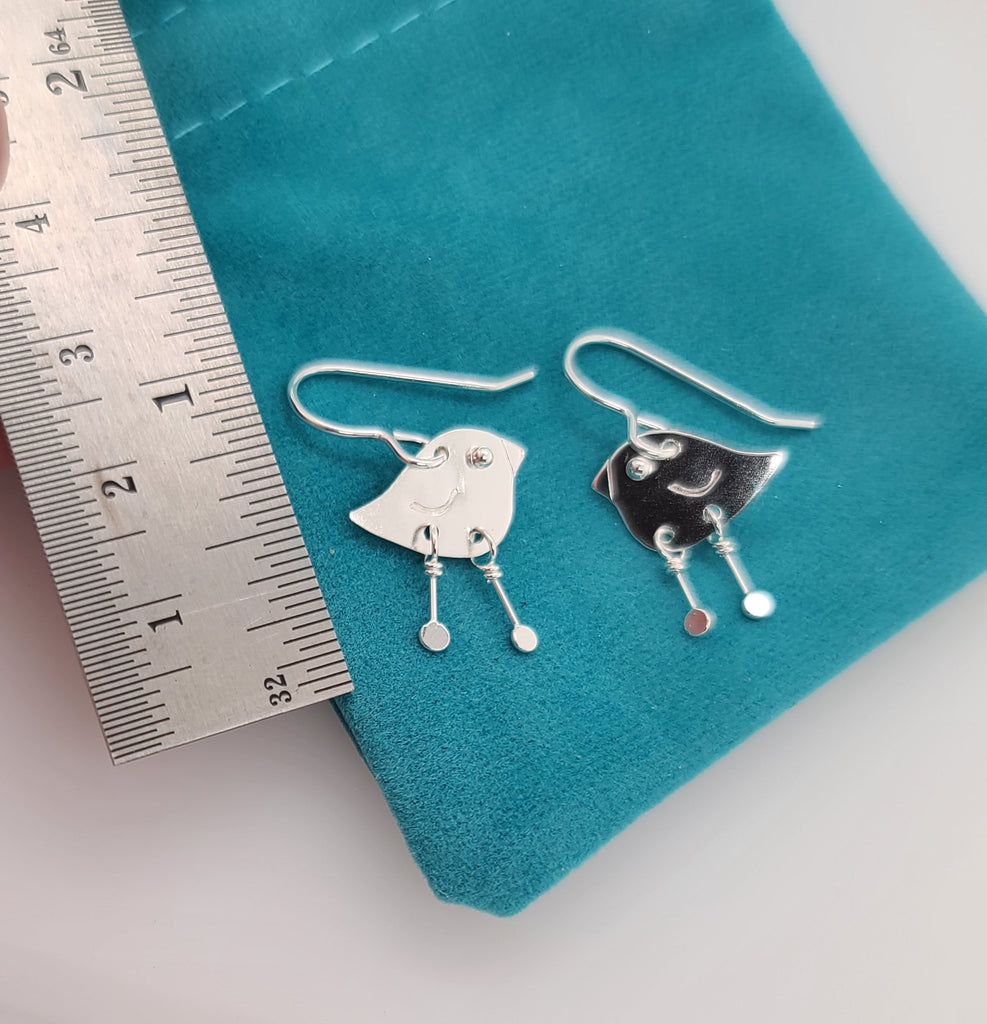 little bird earrings with a ruler for scale