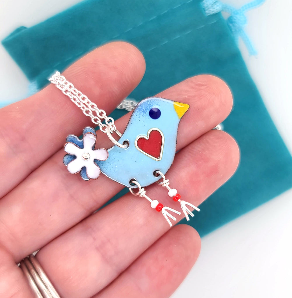 handcrafted bird charm with white flower tail