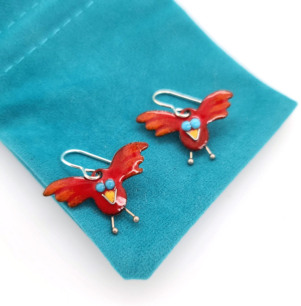 red, blue, and yellow bird earrings