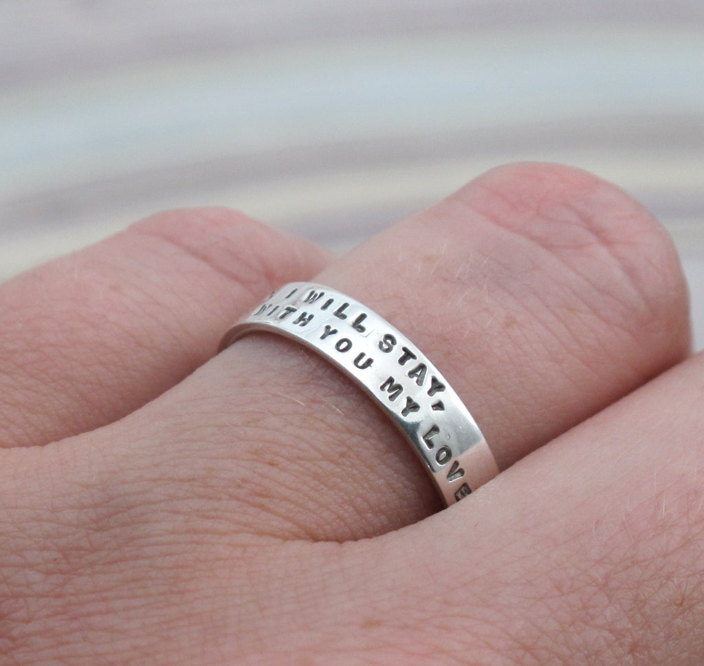 silver ring with 2 lines of lettering