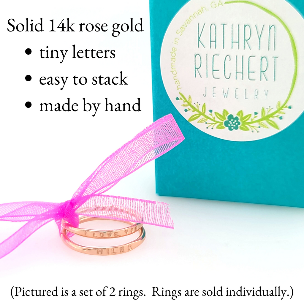 solid 14k rose gold rings tied with ribbon