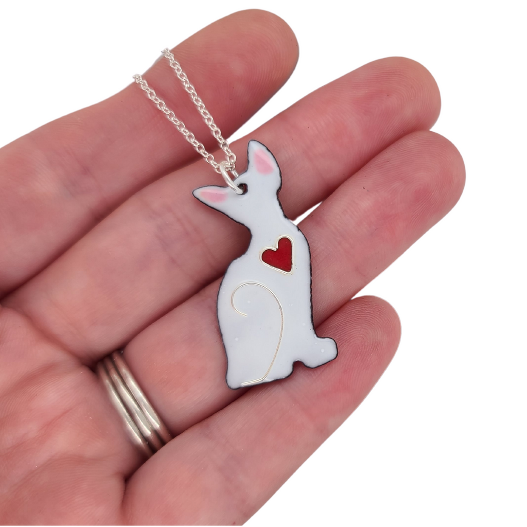white cat charm with red heart